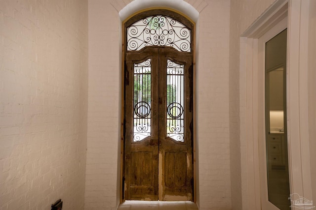 foyer entrance with brick wall and french doors