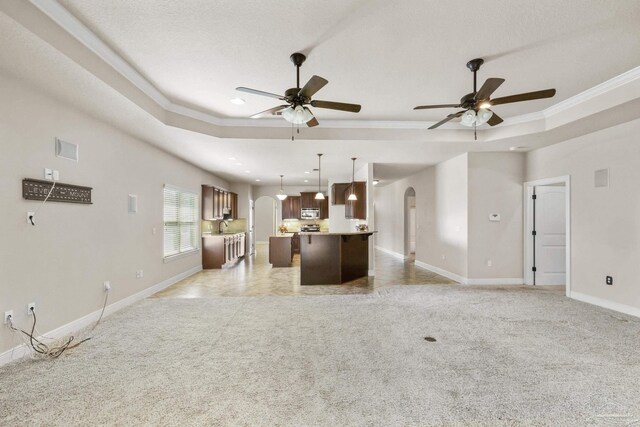 laundry area featuring a textured ceiling, light tile patterned flooring, and washing machine and clothes dryer