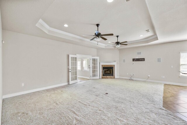 bedroom with ceiling fan, light colored carpet, and a textured ceiling