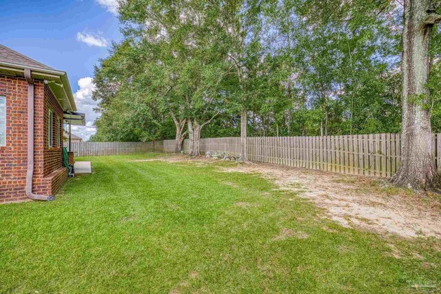 view of side of home with a yard