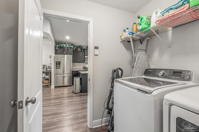 laundry room featuring hardwood / wood-style flooring and independent washer and dryer