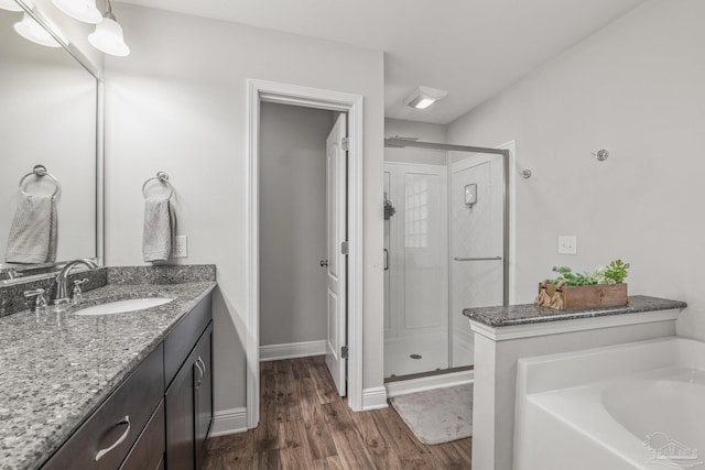 bathroom featuring vanity, hardwood / wood-style floors, and independent shower and bath