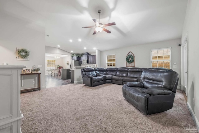 carpeted living room featuring lofted ceiling and ceiling fan