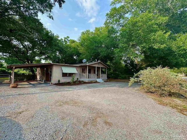 6414 Hamilton Bridge Rd, Milton, FL 32570 - view of front of house featuring covered porch, driveway, and a carport