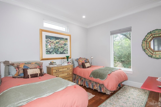 bedroom with ornamental molding and hardwood / wood-style flooring