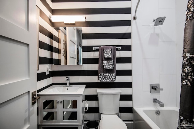 full bathroom featuring tile walls, vanity, toilet, and shower / bath combo with shower curtain