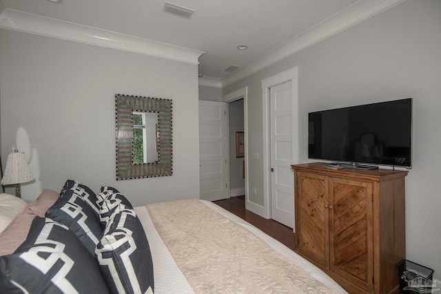 bedroom featuring wood-type flooring and crown molding