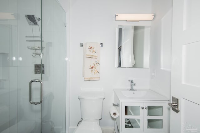 bathroom featuring walk in shower, vanity, and toilet