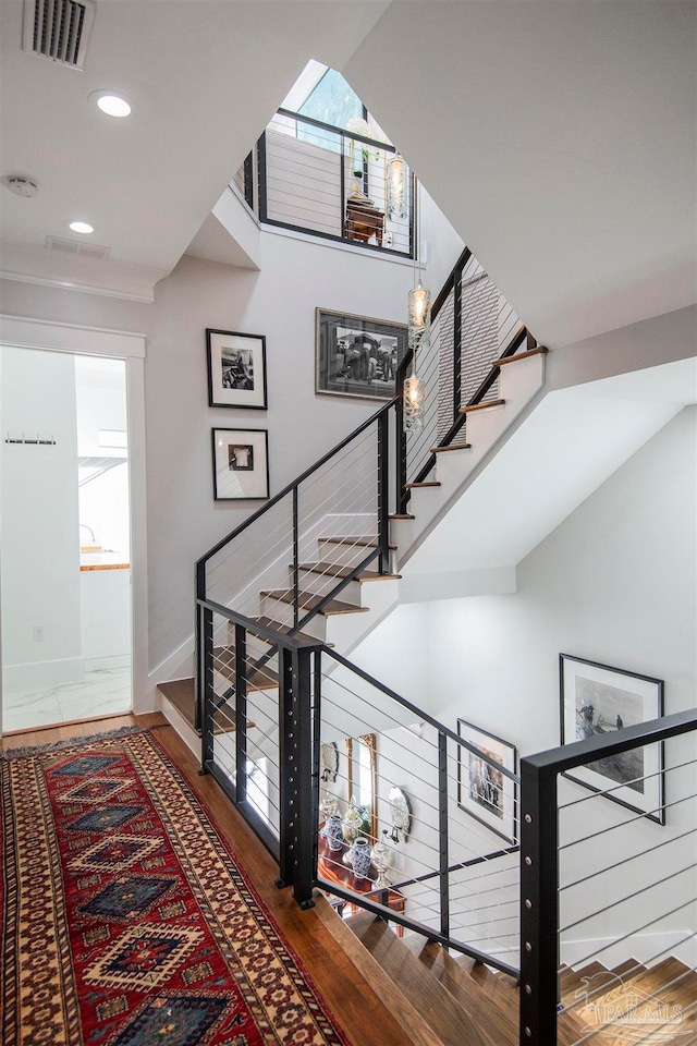 stairs with hardwood / wood-style floors