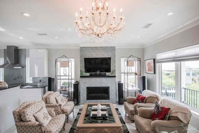 living room featuring an inviting chandelier, a fireplace, and crown molding