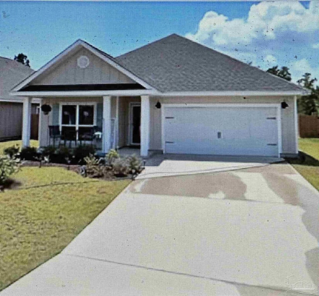 5775 Conley Ct, Pace, FL 32571 - view of front of home featuring covered porch, an attached garage, driveway, and a front yard