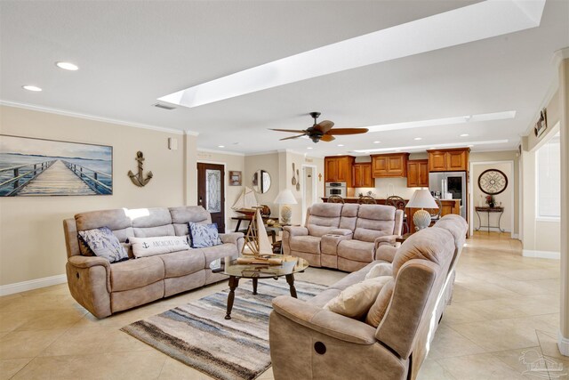 living area featuring ornamental molding, a skylight, baseboards, and recessed lighting