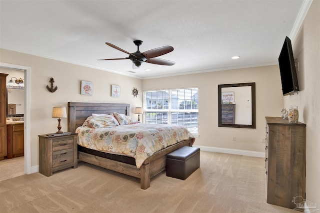 bedroom featuring light carpet, baseboards, a ceiling fan, ornamental molding, and ensuite bathroom