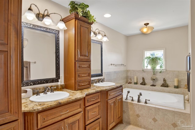 bathroom with a bath, double vanity, and a sink