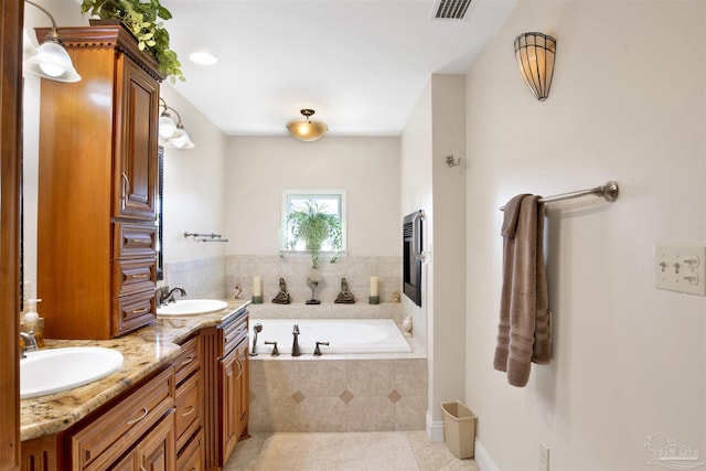 full bath featuring a bath, double vanity, visible vents, and a sink