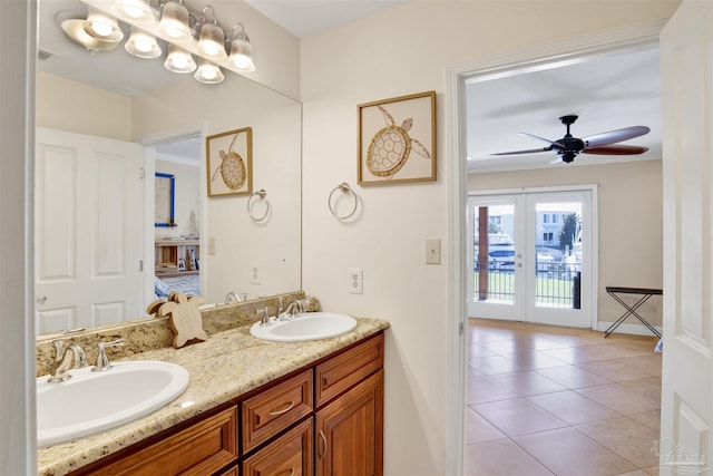 bathroom with tile patterned flooring, french doors, a sink, and double vanity