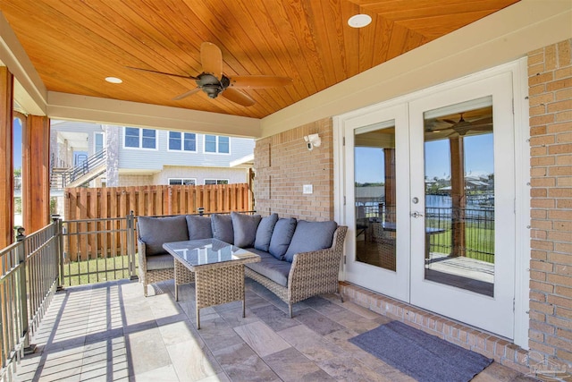 view of patio with a balcony, ceiling fan, an outdoor hangout area, and french doors