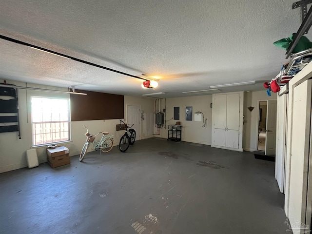 garage featuring electric panel and a garage door opener