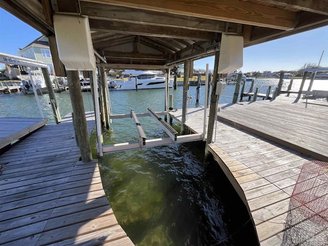 view of dock featuring a water view and boat lift