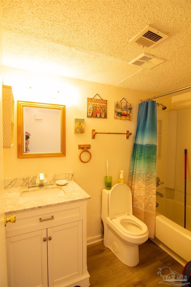 full bathroom with a textured ceiling, toilet, vanity, shower / tub combo, and hardwood / wood-style flooring