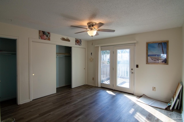 unfurnished bedroom featuring a textured ceiling, dark hardwood / wood-style flooring, access to outside, and ceiling fan