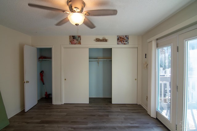 unfurnished bedroom with a textured ceiling, dark hardwood / wood-style flooring, access to outside, and ceiling fan