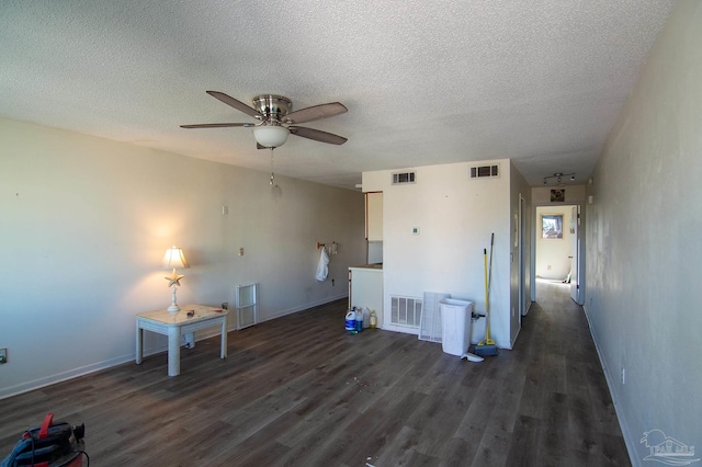 interior space featuring a textured ceiling, dark hardwood / wood-style floors, and ceiling fan