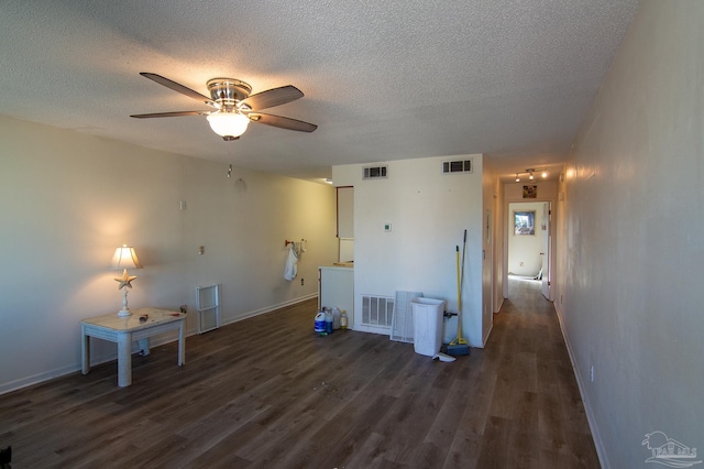 washroom featuring a textured ceiling, dark hardwood / wood-style flooring, and ceiling fan