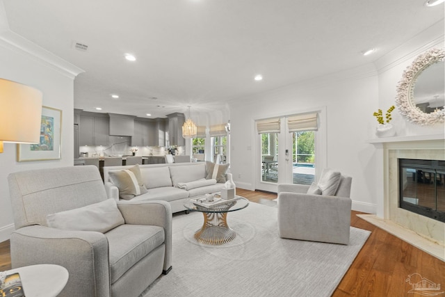 living room with ornamental molding and hardwood / wood-style floors