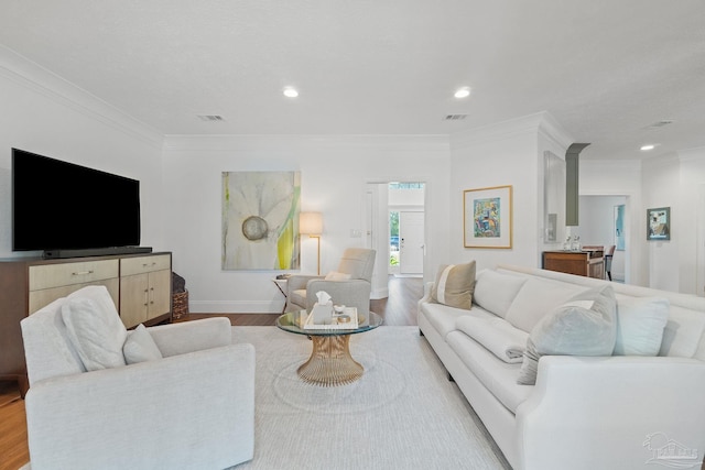 living room featuring ornamental molding and light wood-type flooring