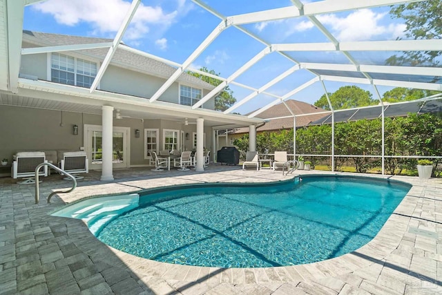 view of swimming pool featuring glass enclosure, a patio, ceiling fan, outdoor lounge area, and central AC unit