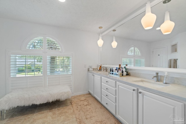 bathroom featuring vanity, a textured ceiling, and tile patterned flooring