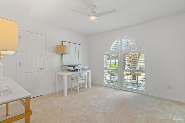 carpeted office featuring ceiling fan