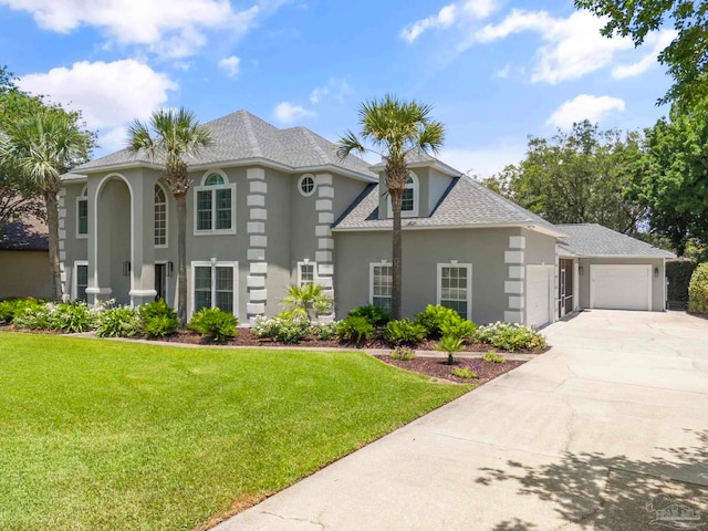 view of front facade featuring a front yard and a garage