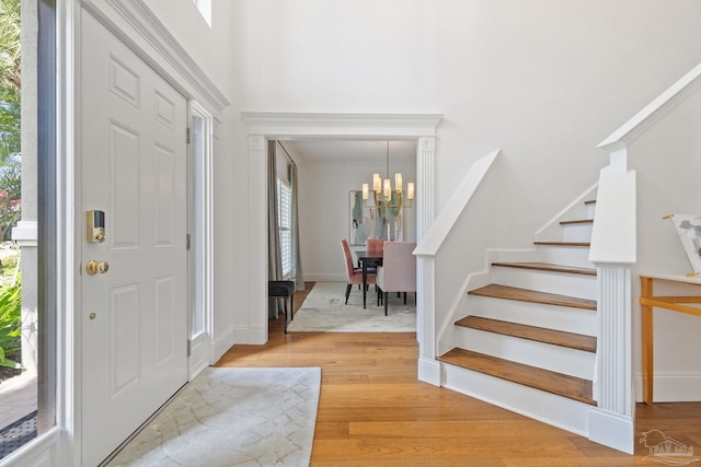 foyer featuring a chandelier and light wood-type flooring