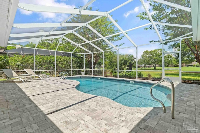 view of pool with a patio and glass enclosure