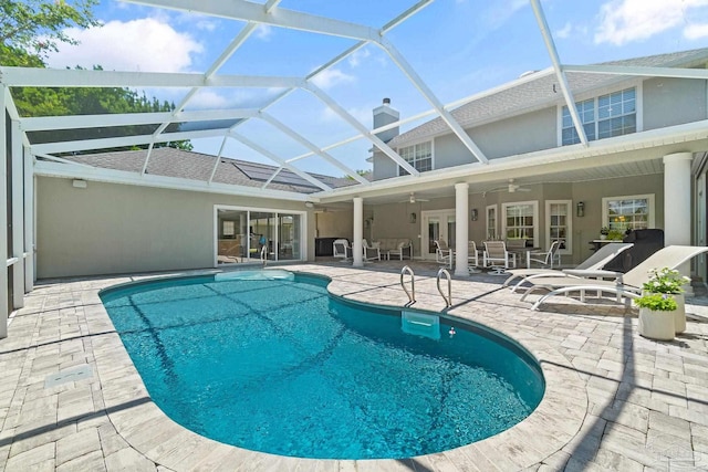 view of swimming pool with a lanai, a patio area, and ceiling fan