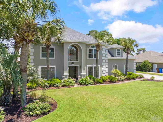 mediterranean / spanish-style home with a front yard