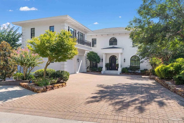 mediterranean / spanish-style house with a garage