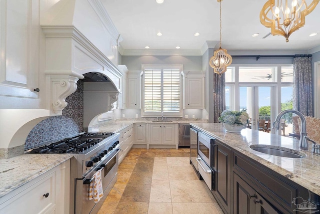 3410 N 18th Ave, Pensacola, FL 32503 - kitchen featuring a sink, white cabinets, appliances with stainless steel finishes, and plenty of natural light
