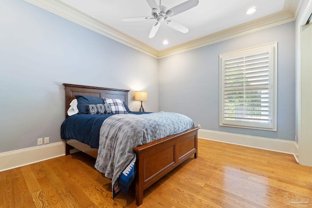 bedroom featuring ceiling fan, light hardwood / wood-style floors, and crown molding