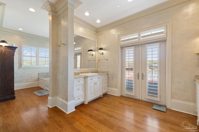 bathroom with ornamental molding, vanity, wood-type flooring, french doors, and ornate columns