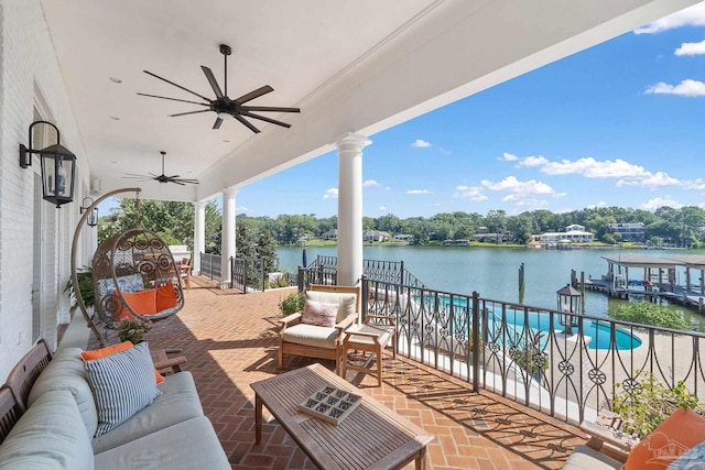 view of patio / terrace with a water view, outdoor lounge area, and ceiling fan