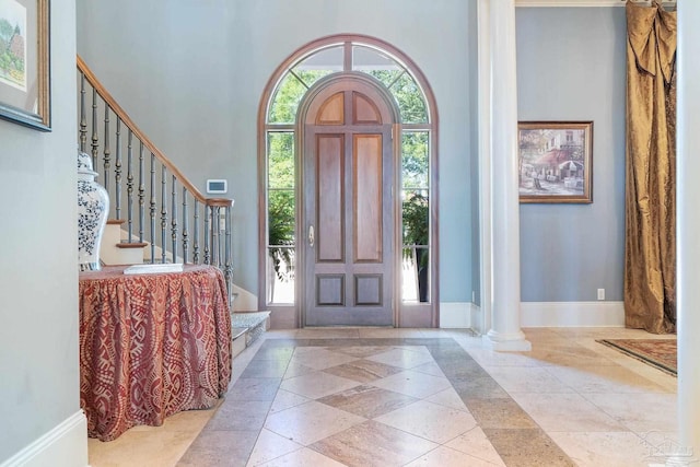 foyer featuring a high ceiling and ornate columns