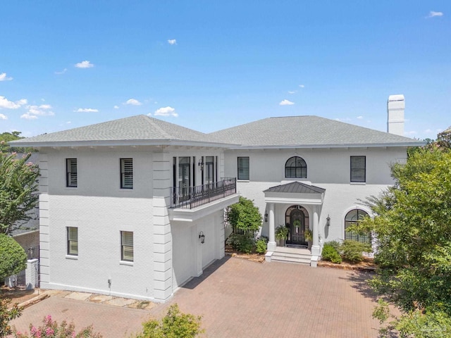3410 N 18th Ave, Pensacola, FL 32503 - view of front of home with a chimney, a balcony, brick siding, decorative driveway, and roof with shingles