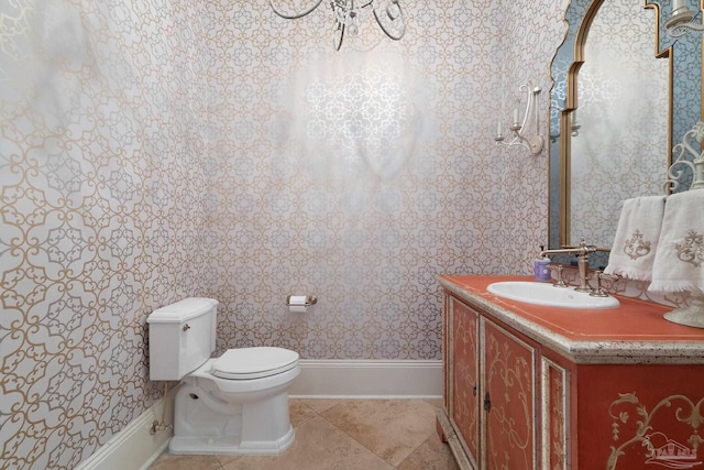 bathroom featuring tile patterned flooring, toilet, and vanity