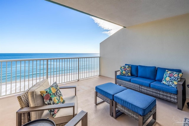 balcony with a water view, an outdoor hangout area, and a beach view