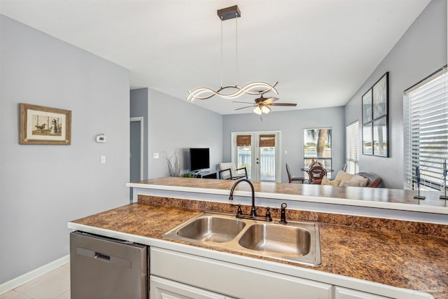 kitchen featuring light tile patterned flooring, ceiling fan, decorative light fixtures, sink, and stainless steel dishwasher