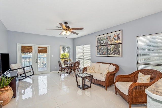 living room featuring ceiling fan, french doors, and light tile patterned floors