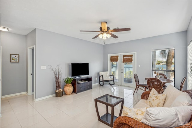 tiled living room with french doors and ceiling fan